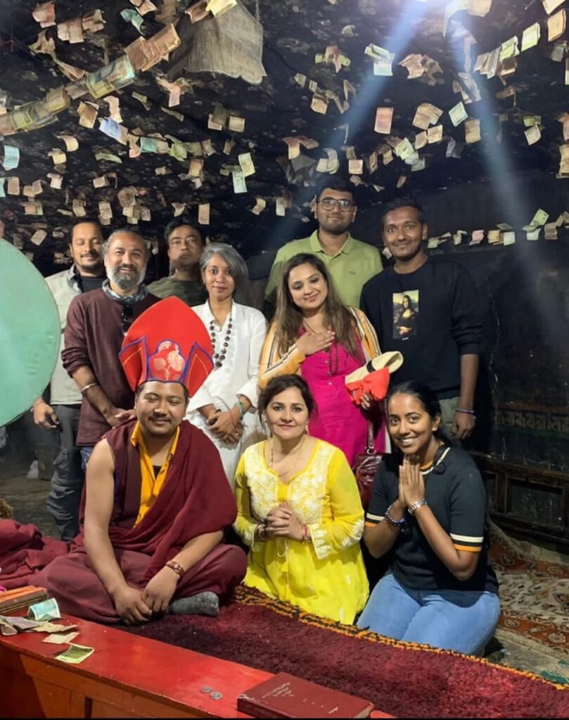 Arhatic Yoga practitioners with a resident monk inside the meditation cave at Takthok Monastery, Ladakh, after a spiritual practice session.