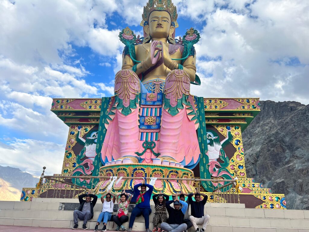 Arhatic Yoga practitioners gathered beneath the Maitreya Buddha overlooking Diskit Monastery and Nubra Valley, Ladakh.